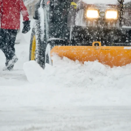 a-person-walking-in-a-snowstorm-with-a-snow-plow-c-2026-01-06-09-04-00-utc